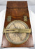 Open Thomas Jones surveying instrument with one brass alidade arm extending across the silvered compass dial.