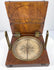 Top-down photograph of the open alidade compass highlighting the silvered degree scale, magnetic needle, and brass sighting components.