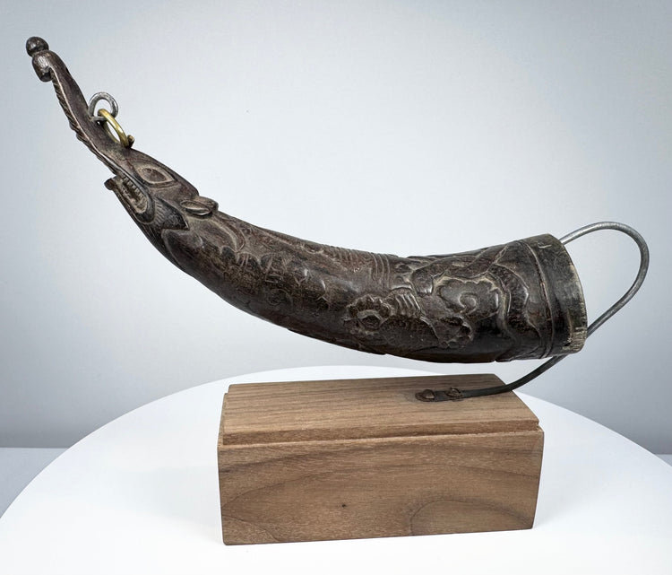 Antique Tibetan carved ritual horn from the Himalayan region, 18th–19th century, with elongated curved form and rich aged patina.