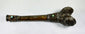 Opposite side of Tibetan human-femur kangling showing two turquoise insets, ornate metalwork and aged patina