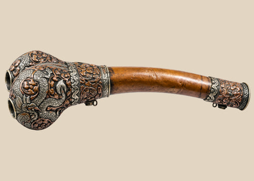 Full-length side view of Tibetan kangling ritual trumpet fashioned from a human femur with ornate metal fittings