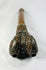 End view of Tibetan human-femur kangling showing the paired openings and engraved metal decoration