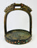 Antique Mongol–Tibetan bronze saddle stirrup with coral and turquoise inlay, upright view on white background.