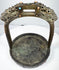 Historic Mongolian or Tibetan stirrup with dark bronze patina, green oxidation, and richly ornamented ceremonial surface.