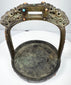 Historic Mongolian or Tibetan stirrup with dark bronze patina, green oxidation, and richly ornamented ceremonial surface.