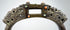 Late Qing dynasty-style bronze equestrian stirrup with pierced metalwork, jeweled inlays, and aged surface encrustation.
