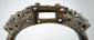 Late Qing dynasty-style bronze equestrian stirrup with pierced metalwork, jeweled inlays, and aged surface encrustation.