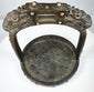 Mongolian or Tibetan equestrian stirrup featuring dragon-head finials, wide tread, and elaborate jeweled decoration.