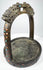Decorative 18th–19th century bronze stirrup with lattice-pattern arch, saddle strap loop, and surviving colored stone inlays.