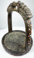 Asian ceremonial horse stirrup with dragon-head terminals, broad footplate, and mixed coral, turquoise, and glass decoration.