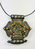 Silver-tone Himalayan gau pendant, filigree, rosette appliqués, coral and turquoise insets, 19th–20th c.