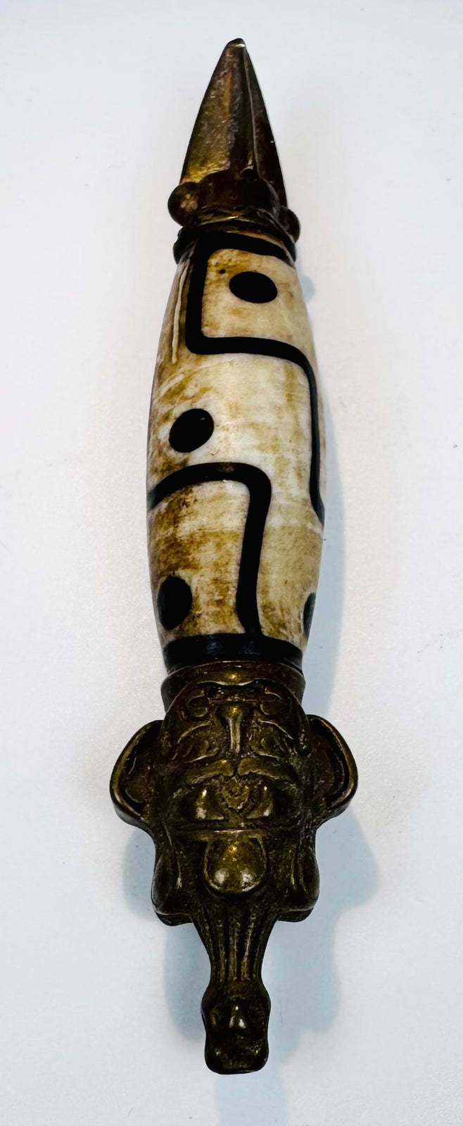 Detailed Tibetan phurba pendant with suspension loop, decorative collars and aged metal patina