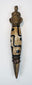 Close-up of Tibetan Dzi-style bead with black geometric motifs and metal ritual fittings