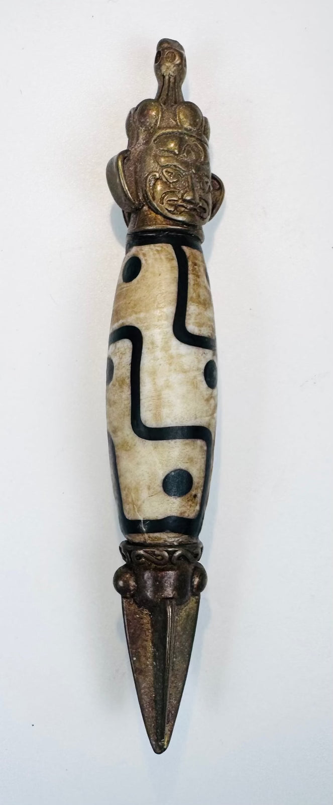 Tibetan Vajrayana-inspired miniature phurba with carved bead and guardian face terminal
