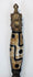 Side view of Himalayan phurba amulet with elongated patterned bead and pointed blade