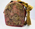 Silver repoussé Tibetan gau shrine housed in traditional embroidered fabric bag