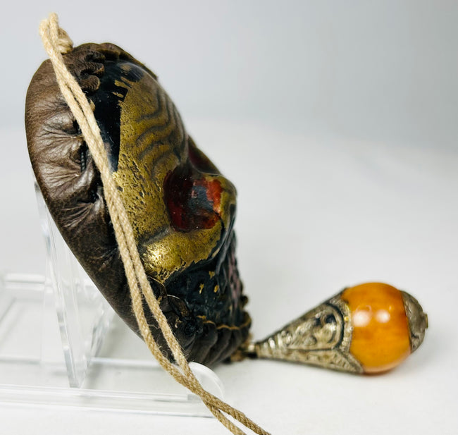 Protective Himalayan skull mask with textile cord suspension