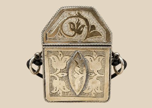 19th century Tibetan silver repoussé gau amulet box, hinged portable shrine with floral and symbolic motifs, original leather strap remnants, Himalayan devotional artifact