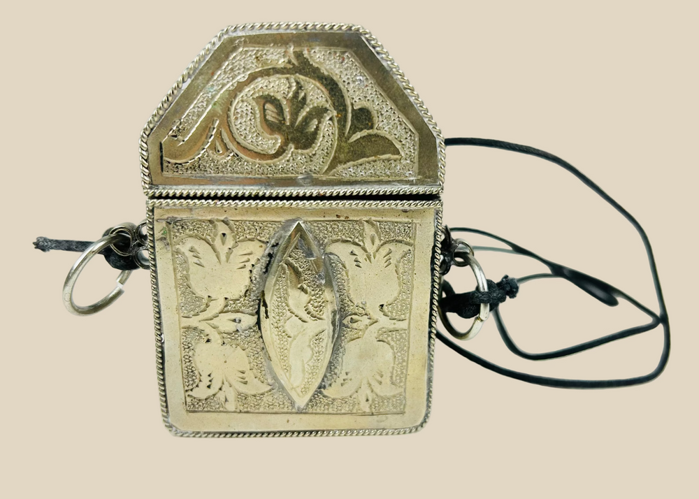 19th century Tibetan silver repoussé gau amulet box, hinged portable shrine with floral and symbolic motifs, original leather strap remnants, Himalayan devotional artifact
