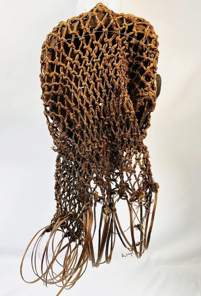 Wooden Chokwe ceremonial mask with intricate forehead patterns and adornments