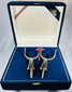 Traditional Chilean espuelas with engraved design and blue velvet display case