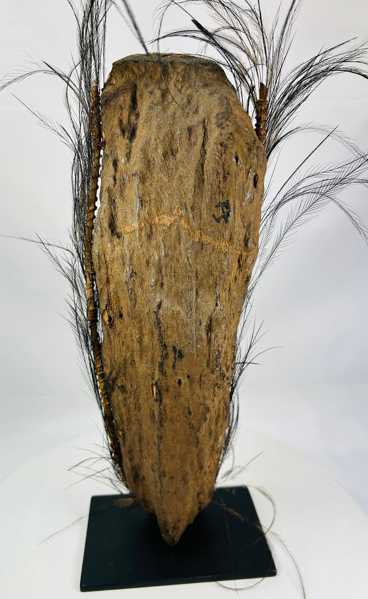 Hand-carved wooden ancestor figure from Papua New Guinea with shell eyes and fiber bindings