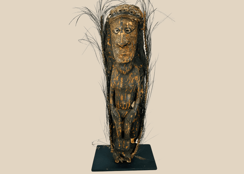 Sepik River Papua New Guinea ancestor figure with shell eyes and feather adornments