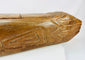 Rear section detail of carved wooden fish drum with zigzag tribal motifs and deep patina.