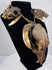 Skull necklace with two smaller skulls along the braided cord and long, tapered teeth suspended beneath them.