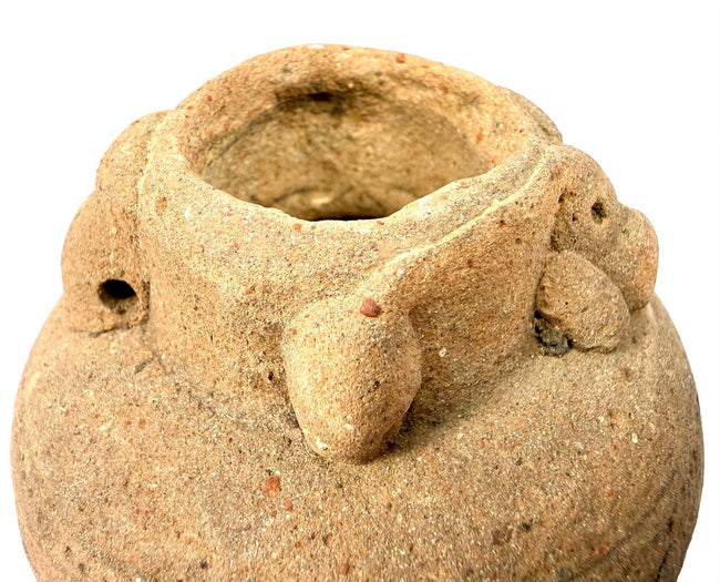 Detail of terracotta vessel rim showing granular clay texture and handle attachment