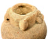 Detail of terracotta vessel rim showing granular clay texture and handle attachment