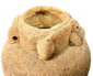 Detail of terracotta vessel rim showing granular clay texture and handle attachment