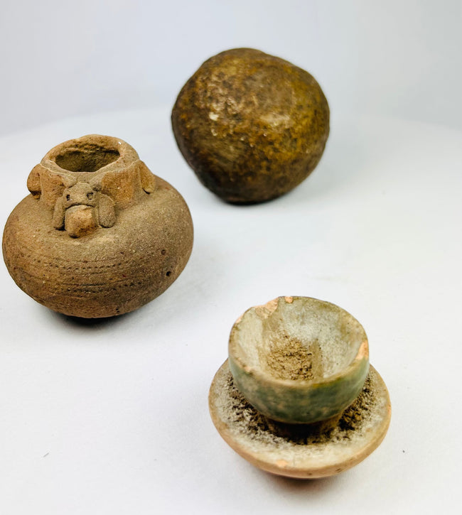 Ancient spherical stone object from South or Southeast Asia, dense polished surface with natural patina, possibly grinding or projectile tool.