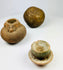 Ancient spherical stone object from South or Southeast Asia, dense polished surface with natural patina, possibly grinding or projectile tool.