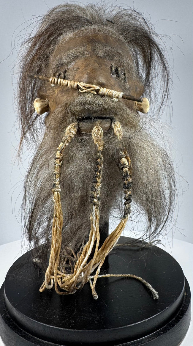 1950s–1960s tsantsa-style curiosity crafted from animal hide, with detailed facial stitching and long dark horse hair.