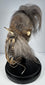 Amazonian shrunken head replica with stitched facial features, textured hide surface, and long horse hair, circa 1950s–1960s.