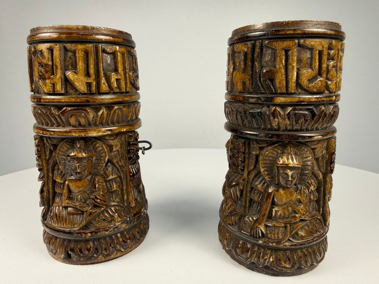 Antique Tibetan human bone prayer wheels with carved Buddha figures and Sanskrit inscriptions