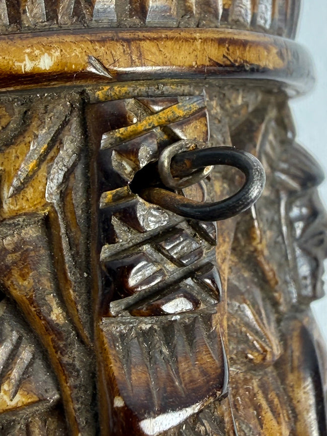 Tibetan Buddhist ritual prayer wheel carved from human femur bone with detailed relief decoration