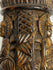 Side view of Tibetan Buddhist human bone prayer wheel with carved devotional imagery