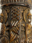 Side view of Tibetan Buddhist human bone prayer wheel with carved devotional imagery