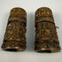 Tibetan Buddhist devotional prayer wheel with carved Buddha figures and sacred inscriptions