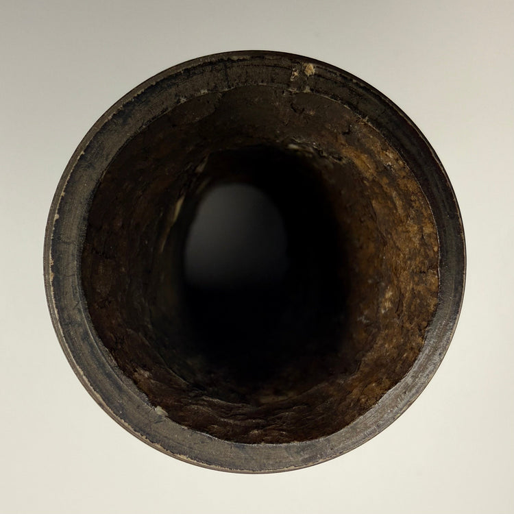 Tibetan human femur bone prayer wheel featuring Buddhist figures and carved inscription band