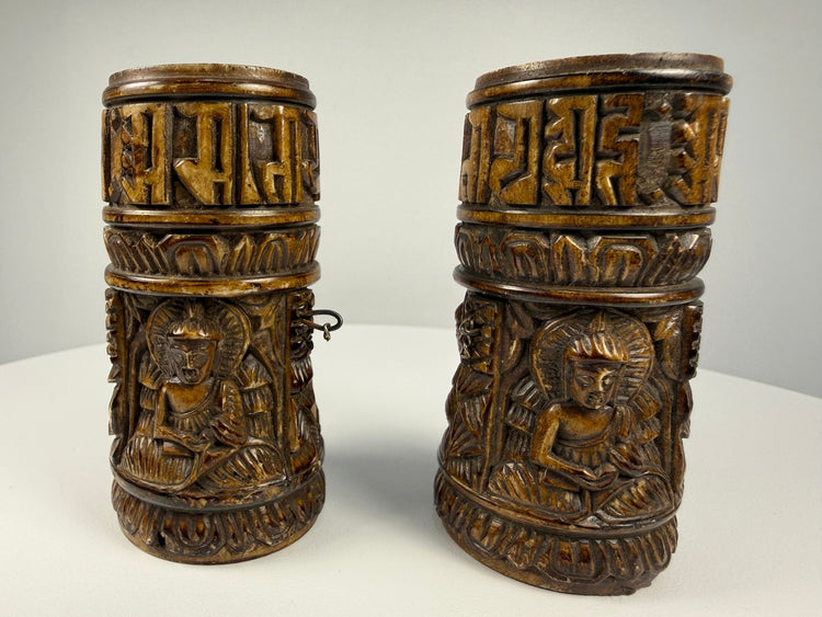 Historic Tibetan ritual prayer wheel made from human thigh bone with intricate Buddhist carvings