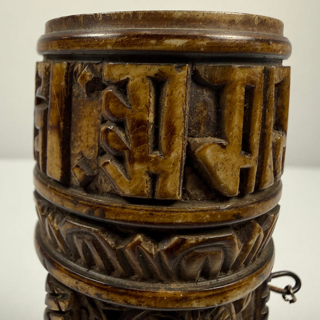 Tibetan Buddhist bone prayer wheel with three Buddha images in different mudra positions