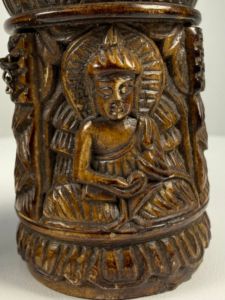 Tibetan Buddhist ritual prayer wheel carved from human femur bone with detailed relief decoration
