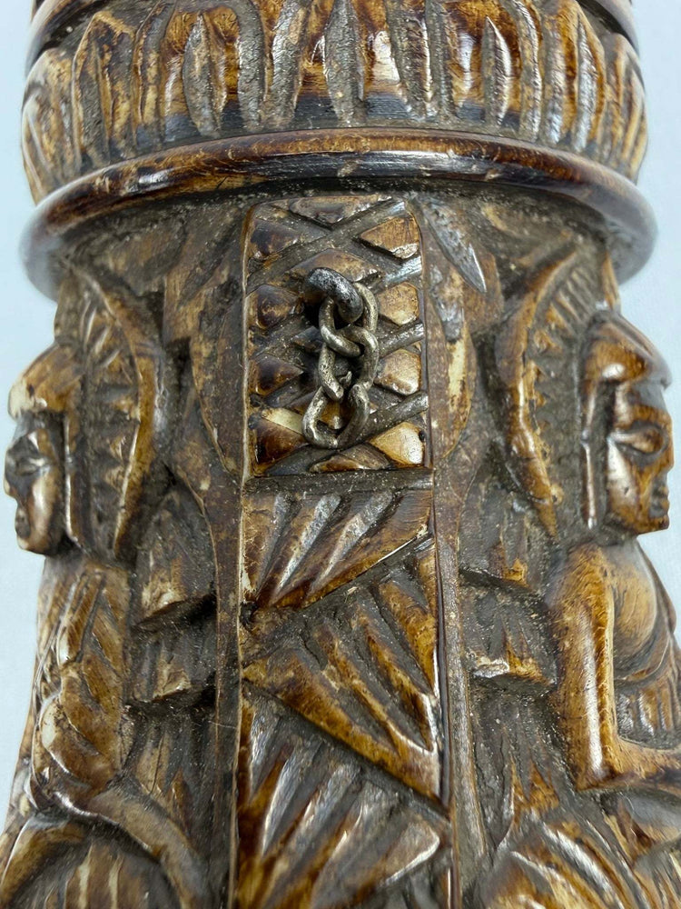Hand-carved Tibetan bone prayer wheel decorated with seated Buddha figures in relief