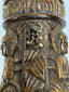 Hand-carved Tibetan bone prayer wheel decorated with seated Buddha figures in relief