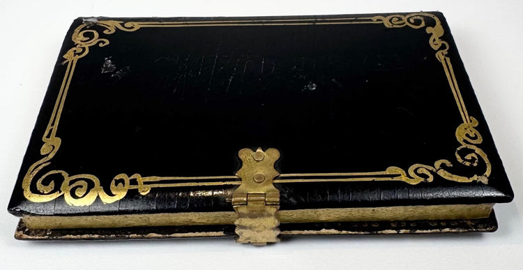 Reverse of Victorian black lacquer calling card case with gilt scrollwork border and brass clasp