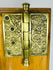 Victorian era brass door hardware with decorative escutcheon and hinge
