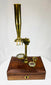 antique scientific microscope instrument in mahogany storage case
